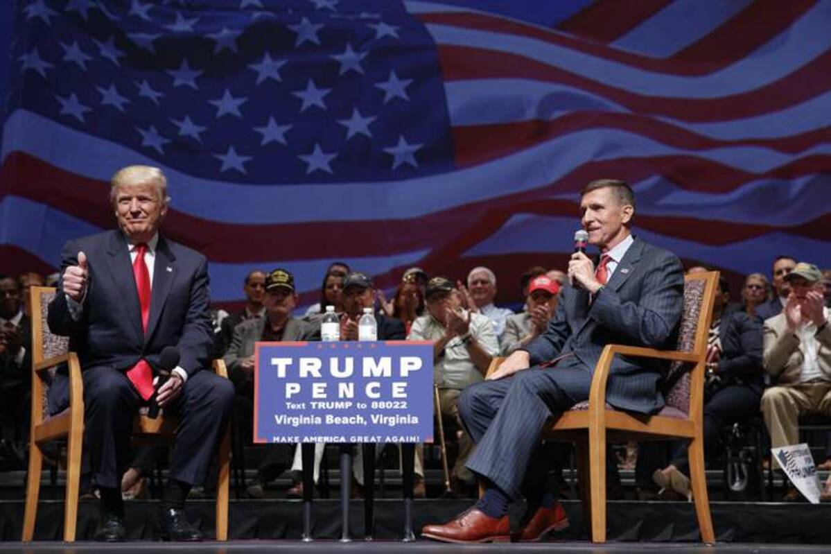 Presidential candidate Donald Trump gives a thumbs-up as he speaks with retired Lt. Gen. Michael Flynn during a town hall on Sept. 6, 2016. (Evan Vucci/AP)