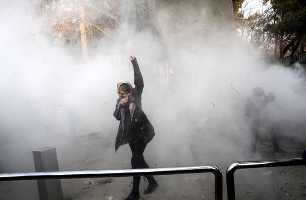 Iranian students clash with riot police during an anti-government protest around the University of Tehran on Dec. 30. (European Pressphoto Agency-EFE)</p>