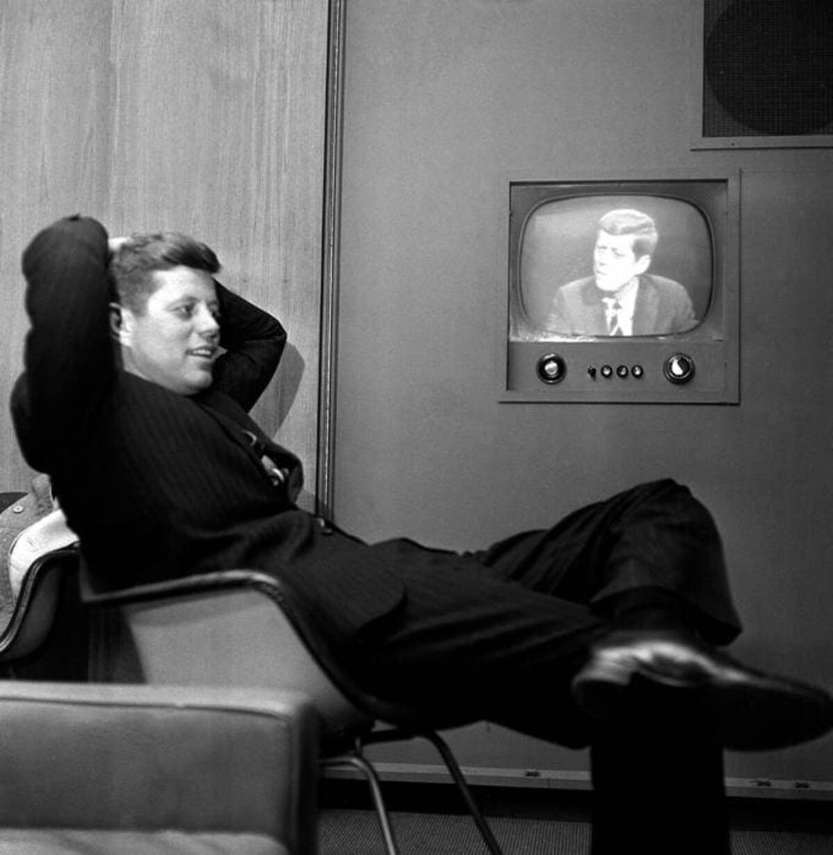 In this April 3, 1960 photo, Sen. John F. Kennedy, Democratic presidential nominee, sits next to a playback of his televised appearance in Milwaukee for the Wisconsin presidential primary two days later. (AP file)