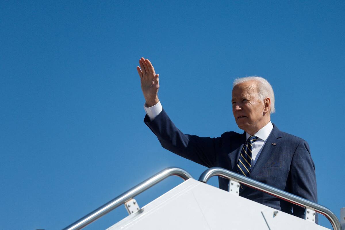 President Biden waves as he boards Air Force One on March 11. (Jonathan Ernst/Reuters)
