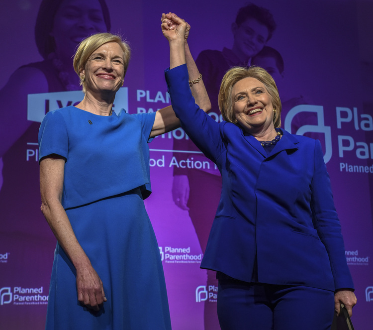 Cecile Richards, the head of Planned Parenthood, joins Hillary Clinton on stage after the Democratic candidate spoke to supporters of the group in June. (Bill O'Leary/The Washington Post)</p>  