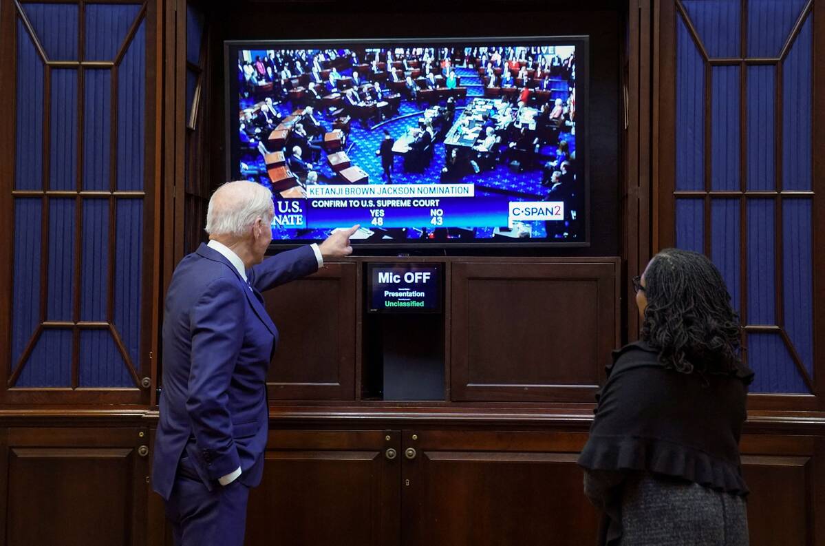 President Biden and Judge Ketanji Brown Jackson watch as the Senate votes to confirm her to the Supreme Court on April 7. (Kevin Lamarque/Reuters)