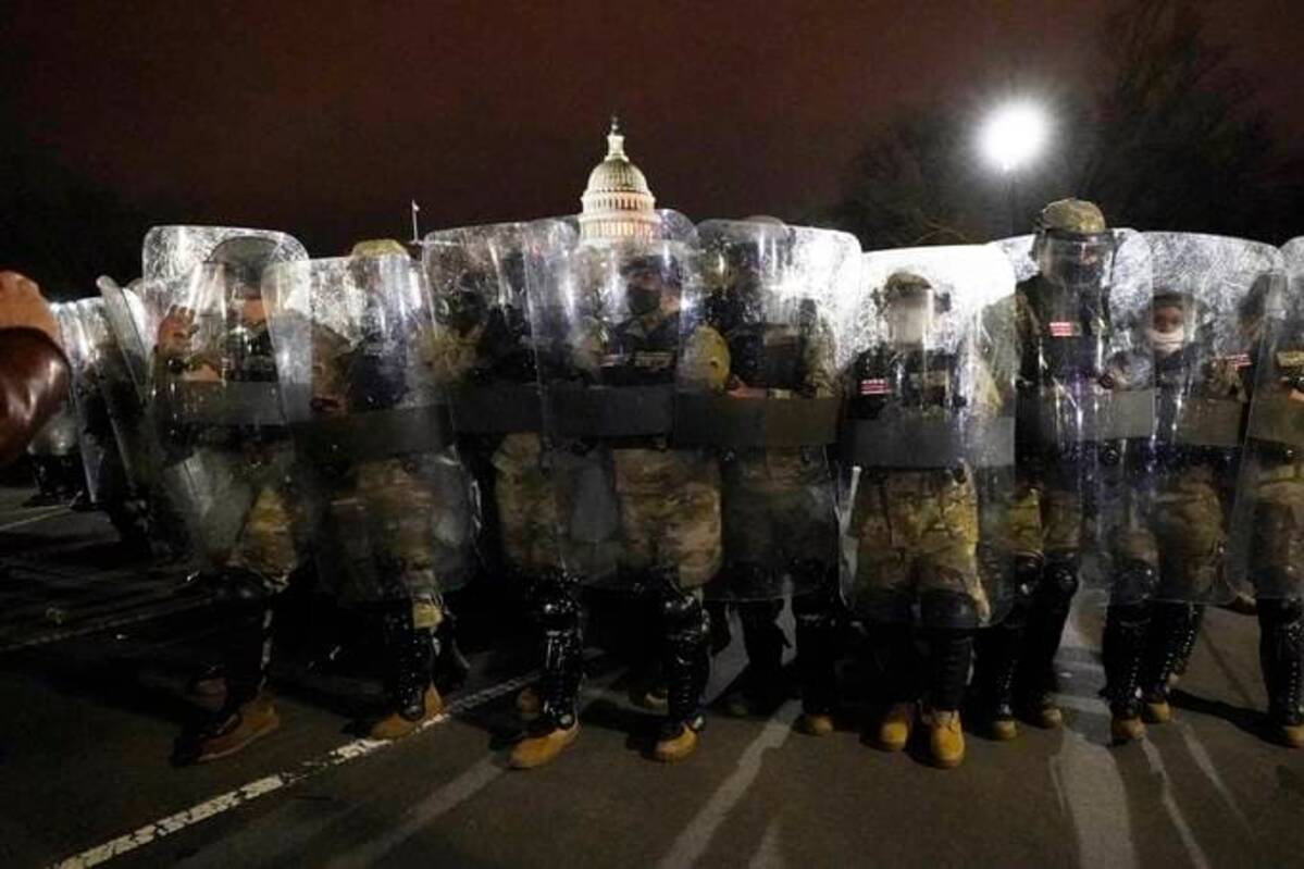 Members of the DC National Guard stand outside the U.S. Capitol on Jan. 6, 2021, after a day of rioting protesters. (Julio Cortez/AP)