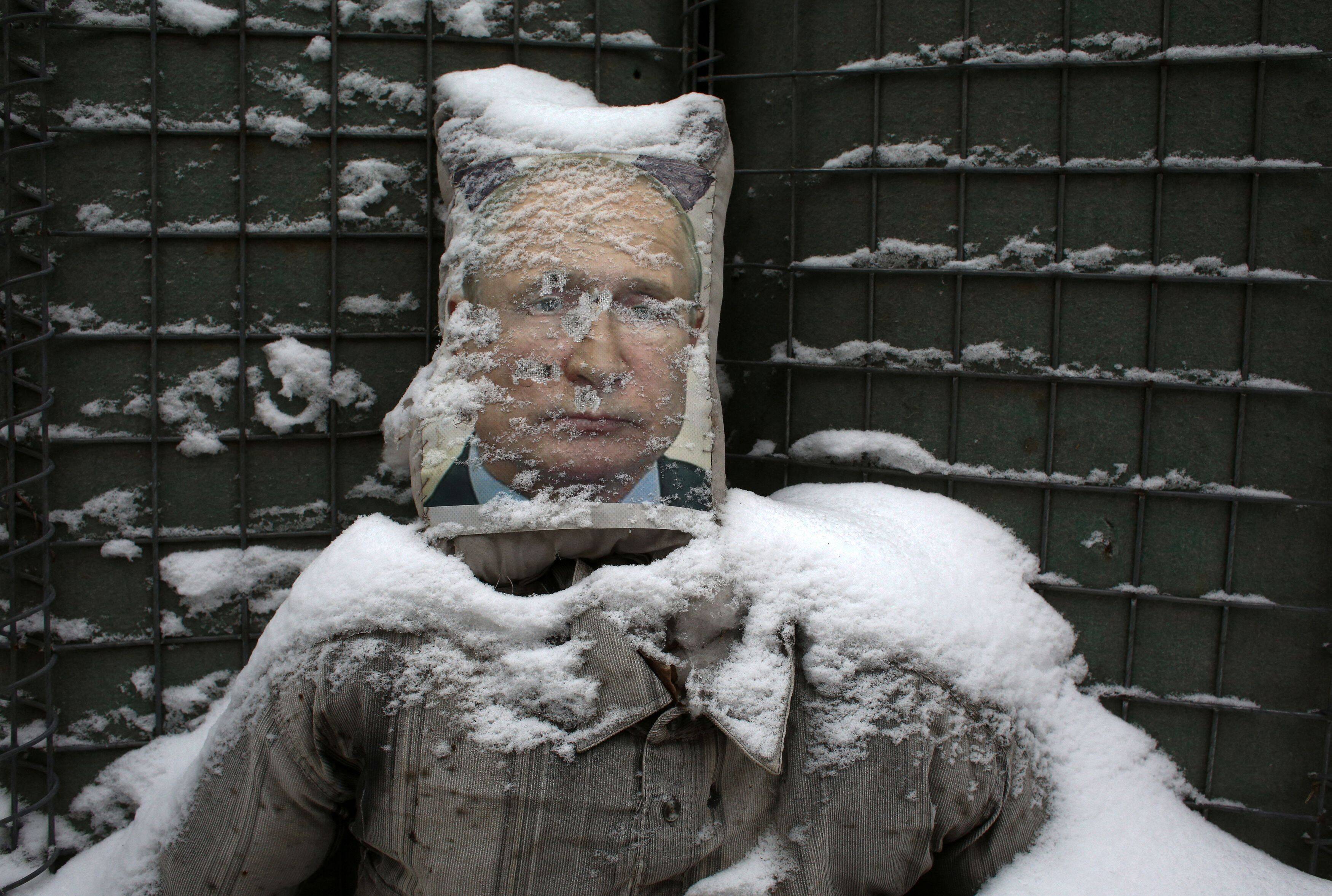 A poster of Russian President Vladimir Putin is used as target practice along a trench on the frontline with Russia-backed separatists near Zolote village, in the Lugansk region, on Jan. 21. (Anatolii Stepanov/AFP)