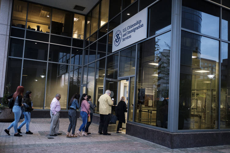People enter the Citizenship and Immigration Services office in the early morning hours in Fairfax, Va. (Pete Marovich/The Washington Post)  