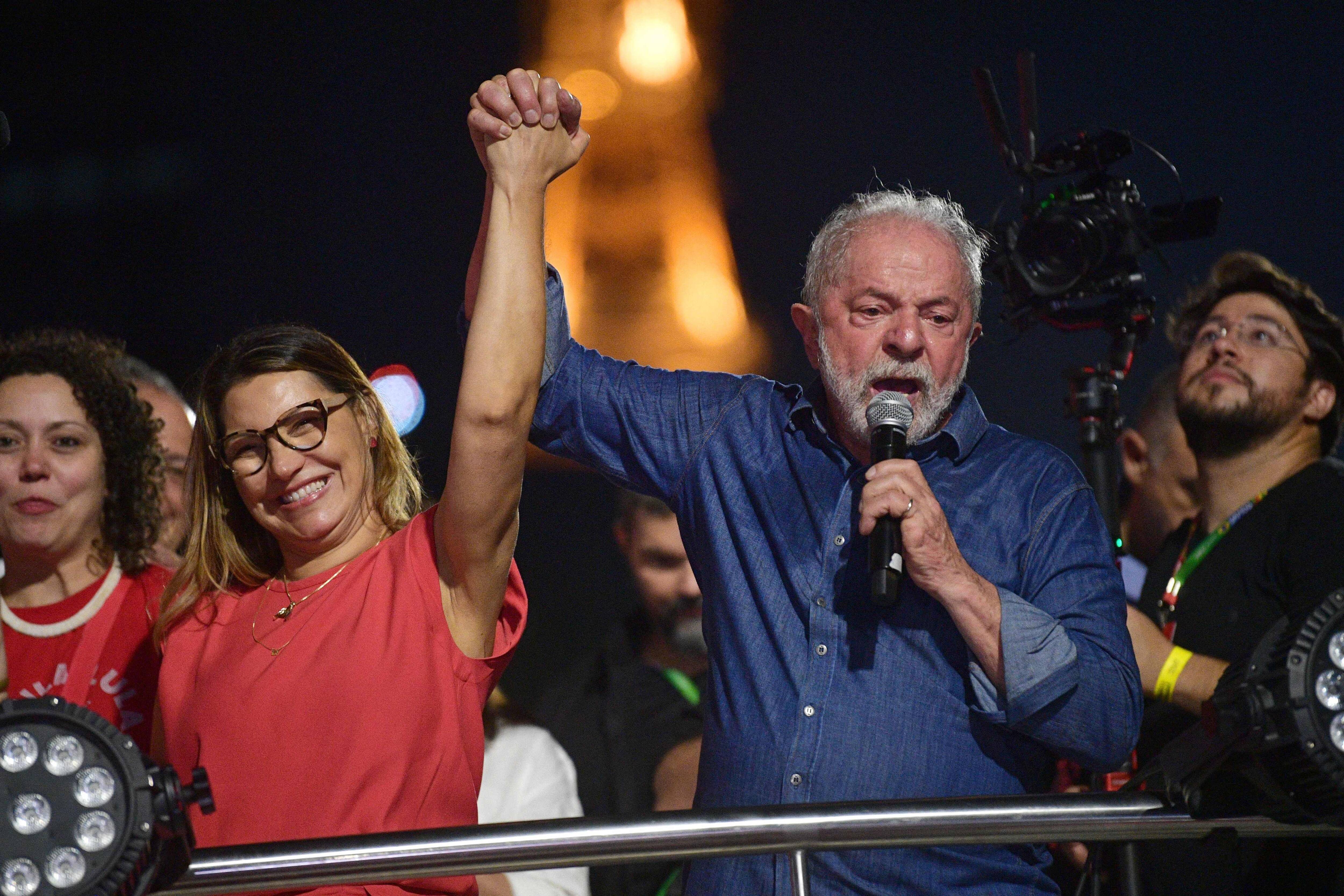 Luiz Inacio Lula da Silva holds the hand of his wife, Rosangela da Silva, after winning the presidential run-off election in Sao Paulo, Brazil, on Oct. 30. (Carol de Souza/AFP via Getty Images)