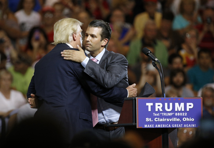 Republican presidential candidate Donald Trump, left, hugs his son Donald Trump Jr. during a rally at Ohio University Eastern Campus about a year ago on June 28, 2016. (AP Photo/Patrick Semansky)  