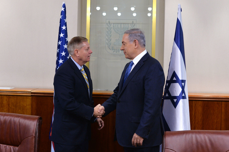 Israel Prime Minister Benjamin Netanyahu confers with Sen.&nbsp;Lindsey Graham (R-S.C.) in Jerusalem in May 2015.&nbsp;(Kobi Gideon/GPO via Getty Images)</p>  