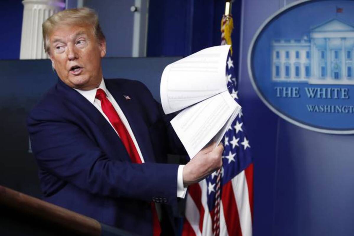 President Donald Trump holds up papers as he speaks about the coronavirus in the James Brady Press Briefing Room of the White House on April 20, 2020. (Alex Brandon/AP)