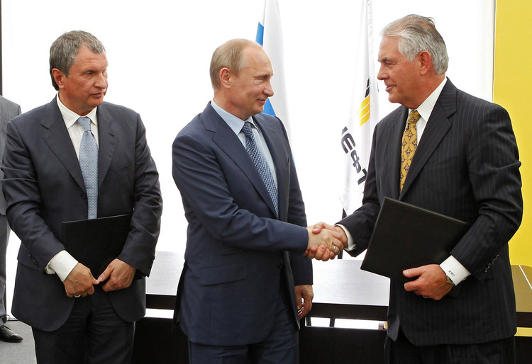 Vladimir and Rex shake hands at a signing ceremony of an agreement between state-controlled Russian oil company Rosneft and ExxonMobil at the Black Sea port of Tuapse in 2012. (RIA-Novosti/AP)</p>  