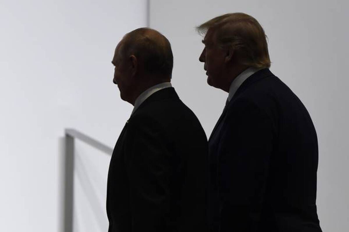 President Donald Trump and Russian President Vladimir Putin walk to participate in a group photo at the G-20 summit in Osaka, Japan, on June 28, 2019. (Susan Walsh/AP)