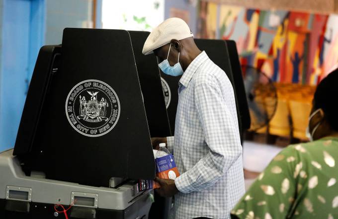 A man votes at Public School 81 in the Bedford-Stuyvesant neighborhood of Brooklyn on Tuesday. (Peter Foley/EPA-EFE/Shutterstock)&nbsp;