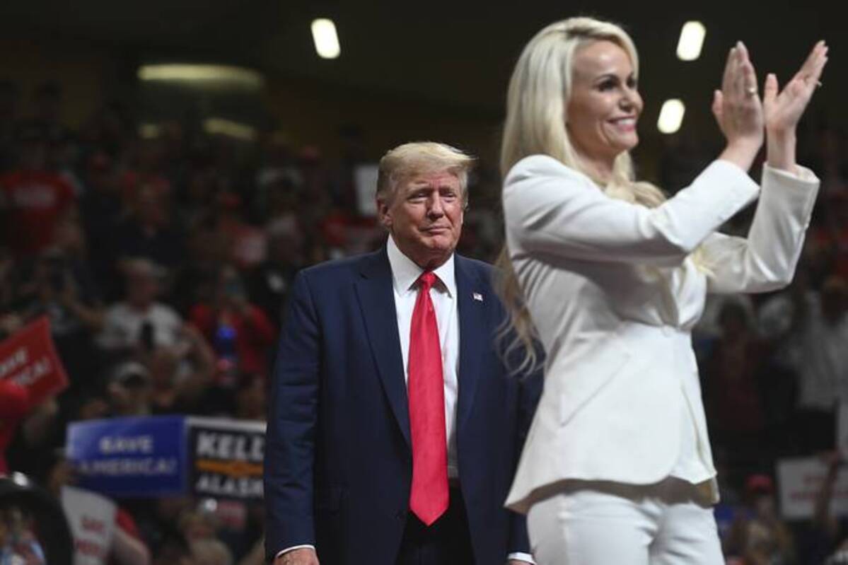 Senate candidate Kelly Tshibaka applauds at a rally with former president Donald Trump at the Alaska Airlines Center, in Anchorage on July 9. (Bill Roth/Anchorage Daily News/AP)