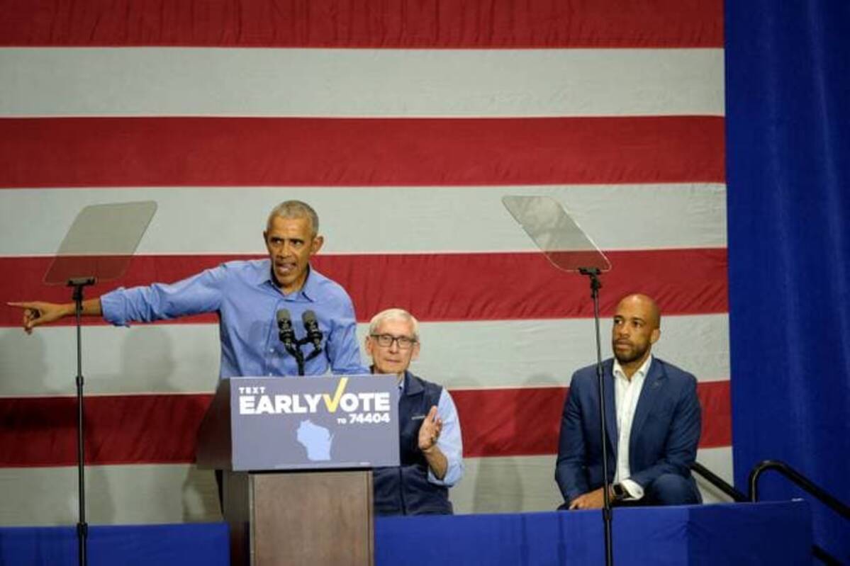 Former president Barack Obama (left) speaks at a rally alongside Wisconsin Governor Tony Evers (center), and Lieutenant Governor Mandela Barnes (right), at North Division High School in Milwaukee, Wis. on Oct. 29. (Alex Wroblewski/The Washington Post)