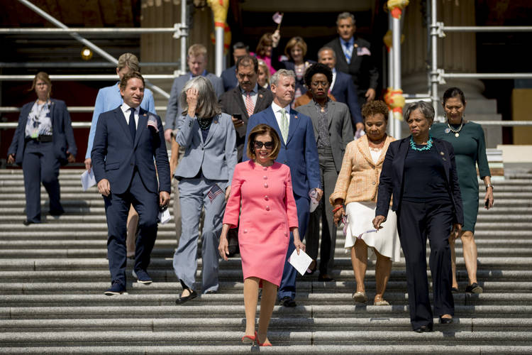 House Speaker Nancy Pelosi walks down the Capitol steps on Thursday for a news conference to discuss the first 200 days of the 116th Congress. (Andrew Harnik/AP)  