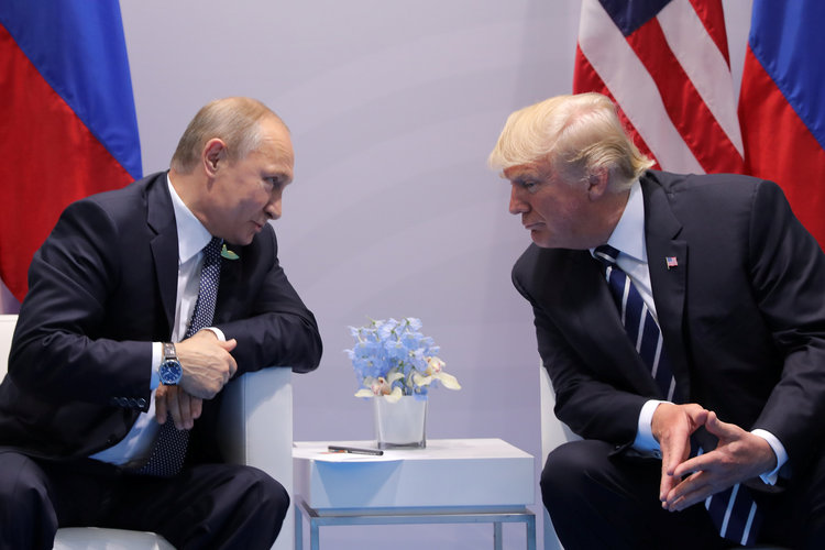 Vladimir Putin and Trump talk during in Hamburg last Friday. (Carlos Barria/Reuters)  
