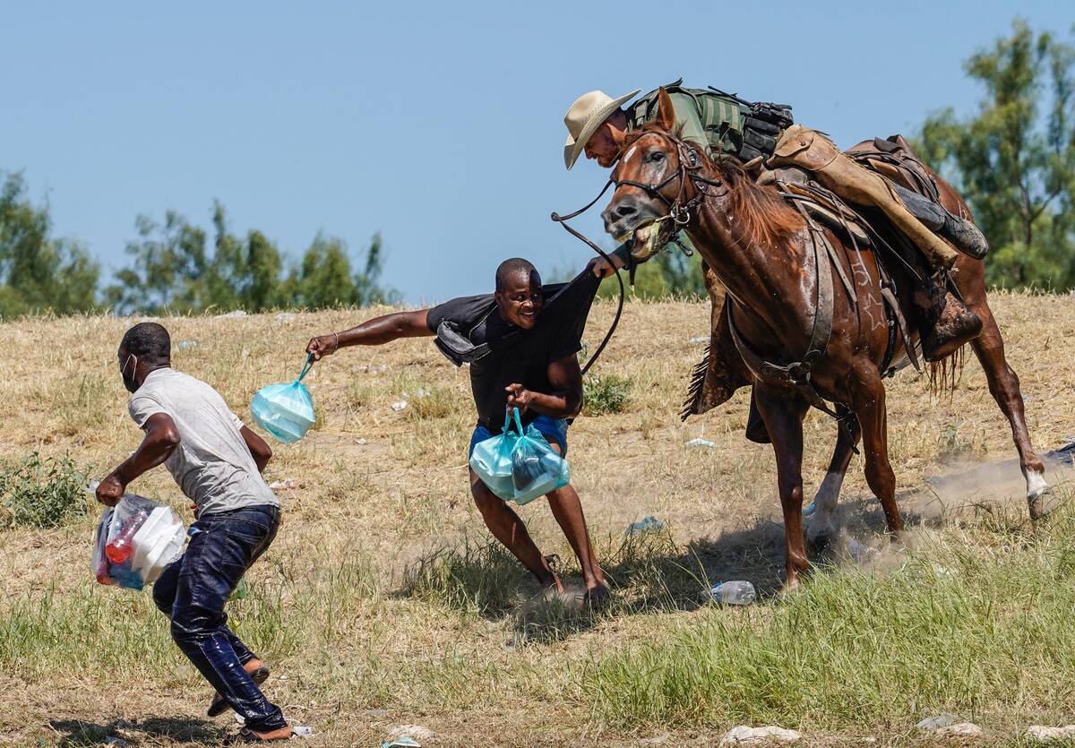 A Border Patrol agent tries to stop a migrant in September in Del Rio, Tex. (Paul Ratje/AFP/Getty Images)