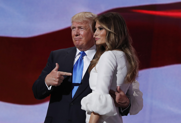 Trump&nbsp;stands with Melania on stage after introducing her Monday night. (Carolyn Kaster/AP)</p>  