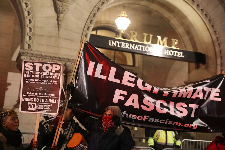 Protesters rallied outside the Trump Hotel last night "to prevent the Trump/Pence regime from coming to power." (Joe Raedle/Getty)</p>
