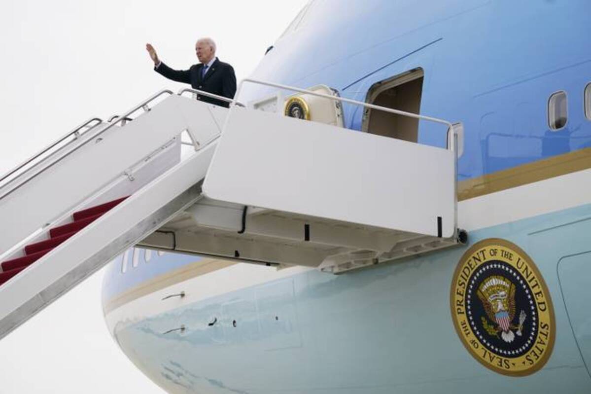 President Biden waves before boarding Air Force One at Andrews Air Force Base, Md., on Wednesday. (Evan Vucci/AP)