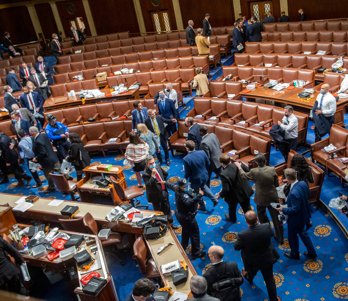 Capitol Police direct members and staff out of the chamber after rioters breach the building on Jan. 6, 2021. (Bill O'Leary/The Washington Post)