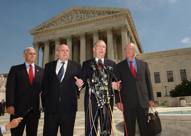 Then-Rep. Mike Pence (R-Ind.), attorney Floyd Abrams, Mitch McConnell and attorney Kenneth Starr speak to reporters outside the Supreme Court after arguing against the constitutionality of the McCain-Feingold campaign finance law in 2003. (Stefan Zaklin/Reuters)</p>  