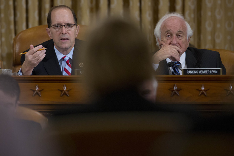 Dave Camp, then chairman of the House Ways and Means Committee, questions CMS chief Marilyn Tavenner during a hearing with ranking member Sander Levin back in 2013. (Andrew Harrer/Bloomberg)</p>  
