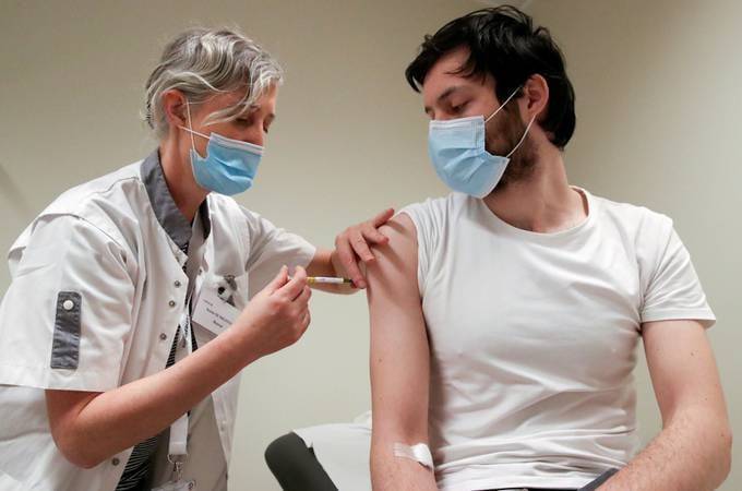 A volunteer receives a dose of CureVac vaccine or a placebo. (Yves Herman/Reuters)