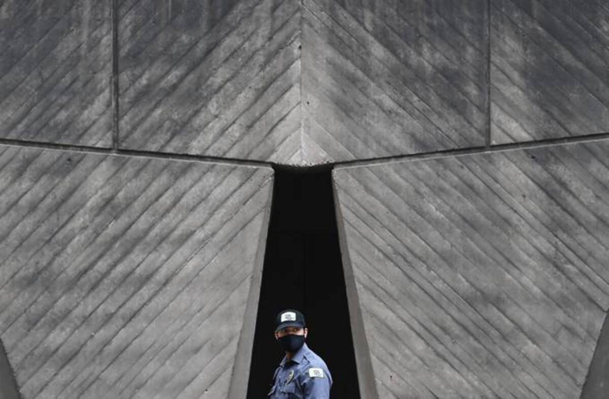 A security member walks outside the Department of Housing and Urban Development. (Matt McClain/The Washington Post)