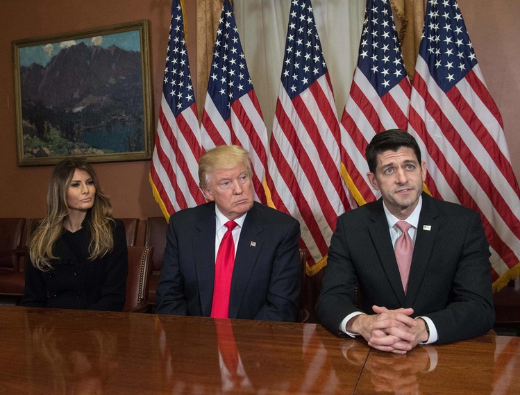 Donald and Melania listen as Paul Ryan speaks to the press in the Capitol. (Nicholas Kamm/AFP/Getty Images)</p>  