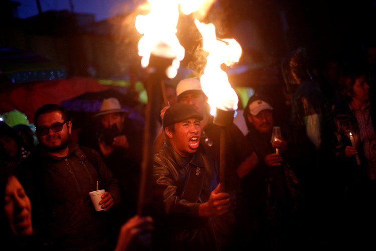A protester from the National Coordination of Education Workers teachers' union holds a torch as he yells during a march last night in Mexico City.&nbsp;(Reuters/Edgard Garrido)</p>  