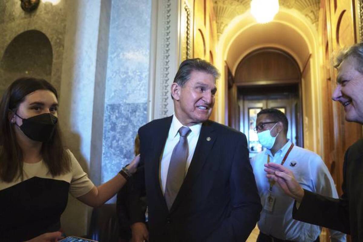 Sen. Joe Manchin III (D-W.Va.), who has been a key holdout on President Biden's ambitious domestic package, speaks with Sen. John Neely Kennedy (R-La.) right, as he leaves the chamber after a vote, at the Capitol in Washington. (J. Scott Applewhite/AP)
