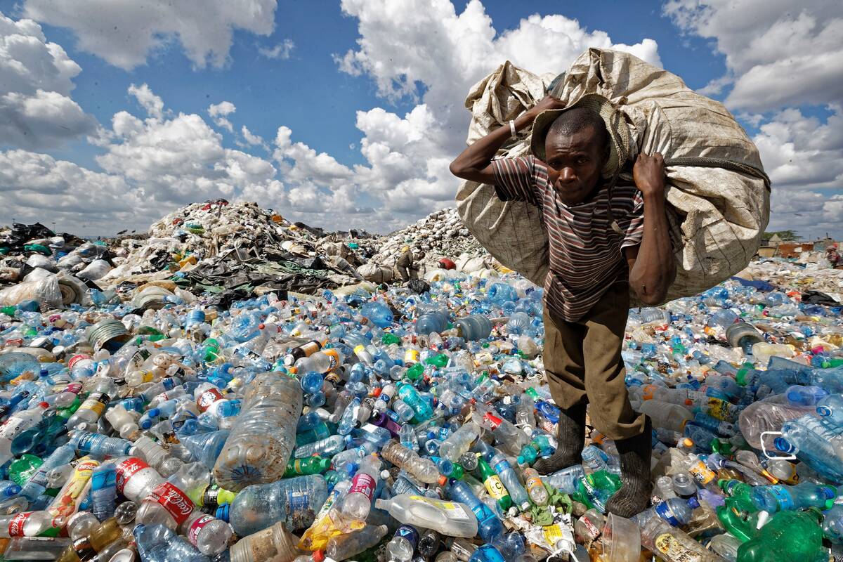 A man in Nairobi carries plastic bottles on Dec. 5, 2018. (Ben Curtis/AP)