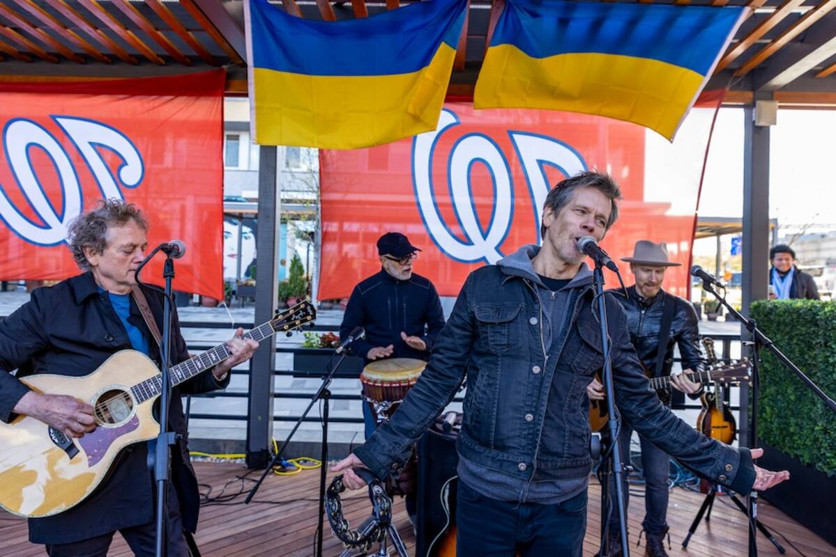 Michael Bacon, left, and Kevin Bacon of the Bacon Brothers perform during a benefit show for Ukraine relief on Sunday at Dacha Beer Garden in Washington's Navy Yard neighborhood. (Tasos Katopodis/Getty Images)