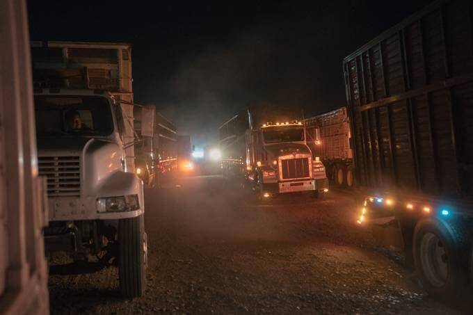 A truck driver waits on a May night to deliver wheat to Ferropuerto de Sonora, a cargo transportation company. The families who grow wheat in Mexico's Yaqui Valley export much of their crop to countries in Africa and Latin America. (Luis Antonio Rojas/The Washington Post)