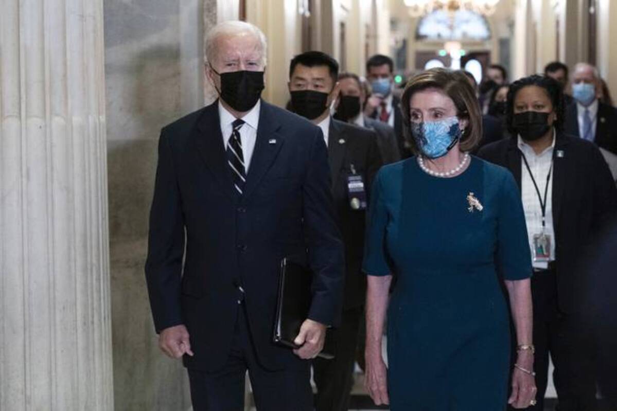 Biden walks with Speaker of the House Nancy Pelosi of Calif., on Capitol Hill in Washington, Thursday. (AP Photo/Jose Luis Magana)