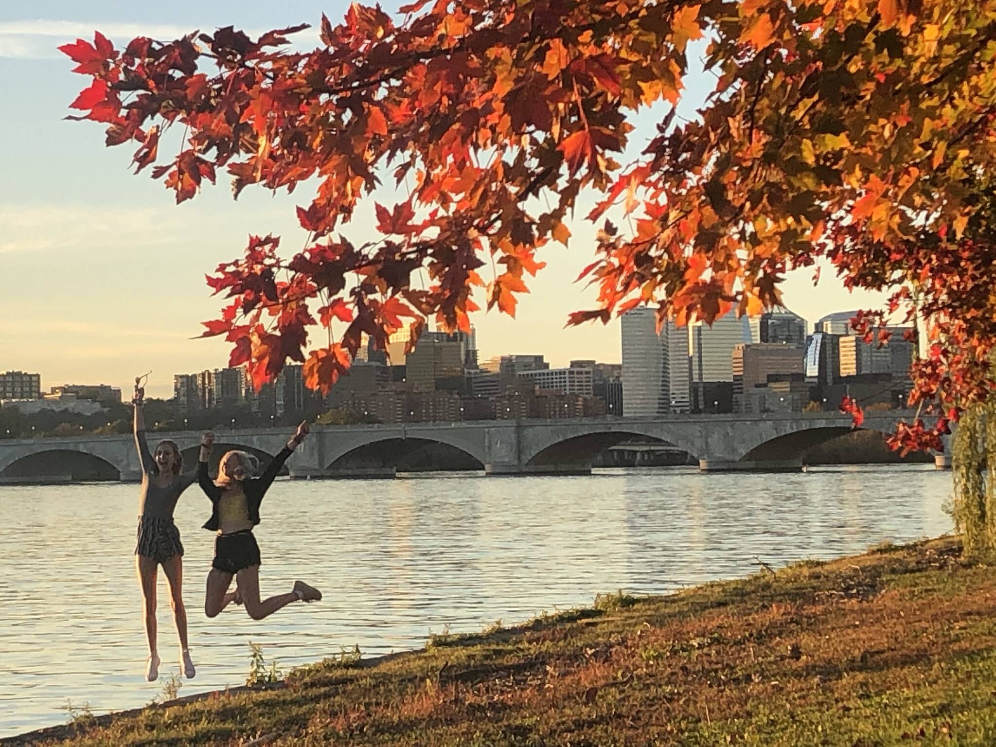 Fall foliage along the Potomac River near Memorial Bridge with people enjoying the mild autumn weather Monday. (Jeannie in D.C./Flickr)
