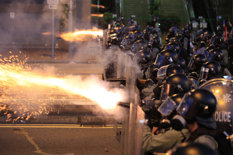 Hong Kong police fire tear gas at protesters in Sai Wan on Sunday. (Jeff Cheng/HK01 via AP)  