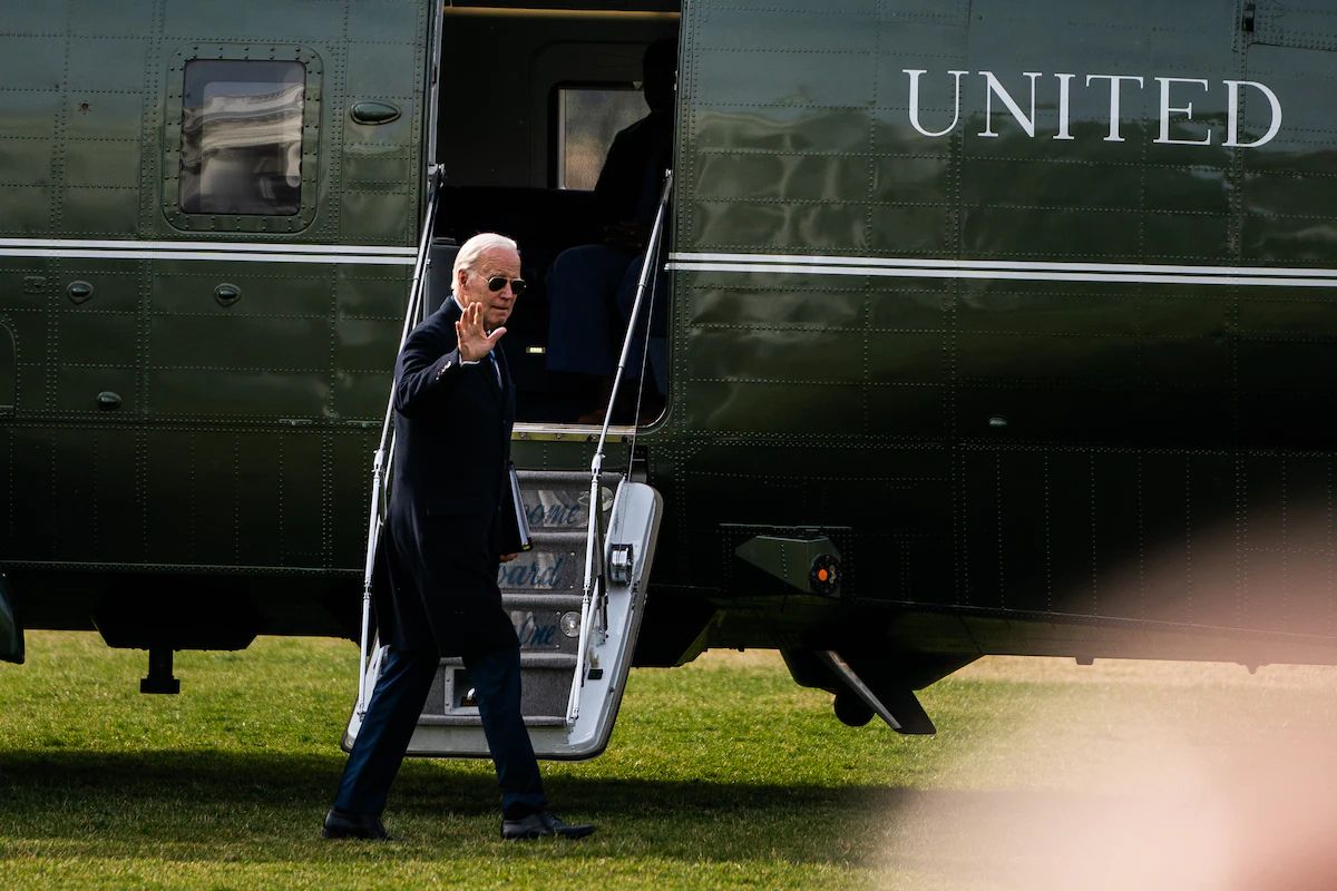 President Biden waves during his walk to the Oval Office on the South Lawn of the White House on Monday. (Demetrius Freeman/The Washington Post)