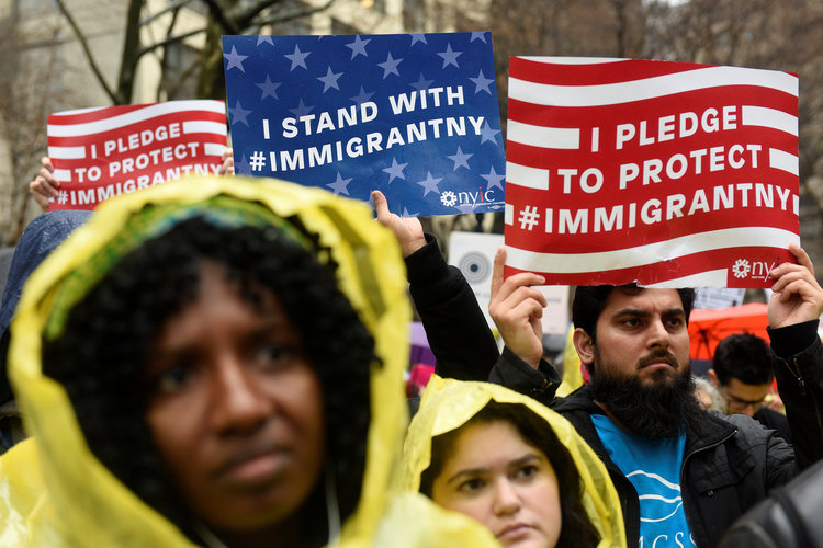 People hold up signs before marching to Trump Tower during a protest last month. (Darren Ornitz/Reuters)</p>  