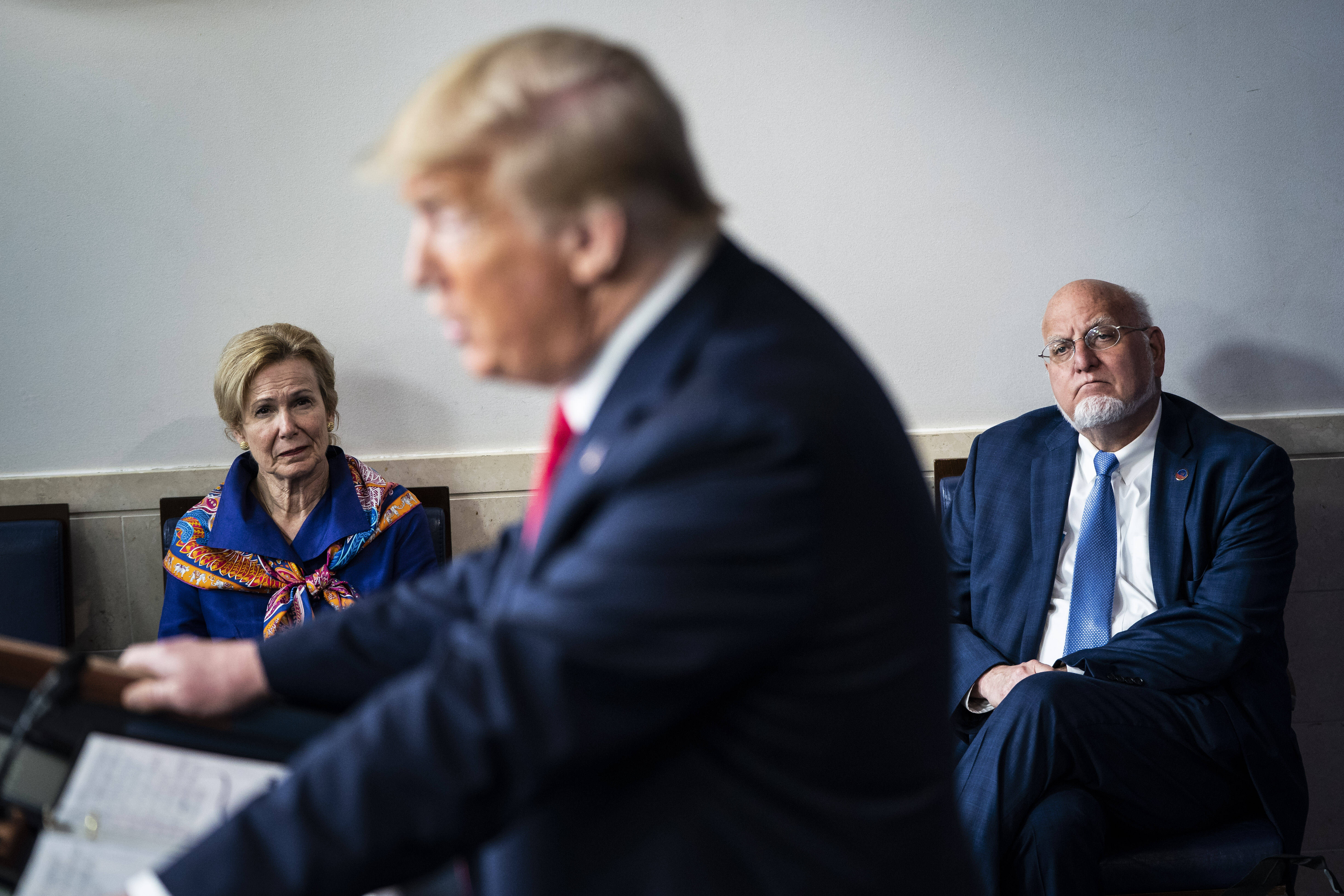 Deborah Birx, then-White House coronavirus response coordinator, listen to Donald Trump speak in April 2020.