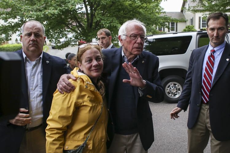 Bernie Sanders&nbsp;waves goodbye after holding a press conference in&nbsp;front of his home yesterday&nbsp;in Burlington, Vt.&nbsp;(AP Photo/Cheryl Senter)</p>  