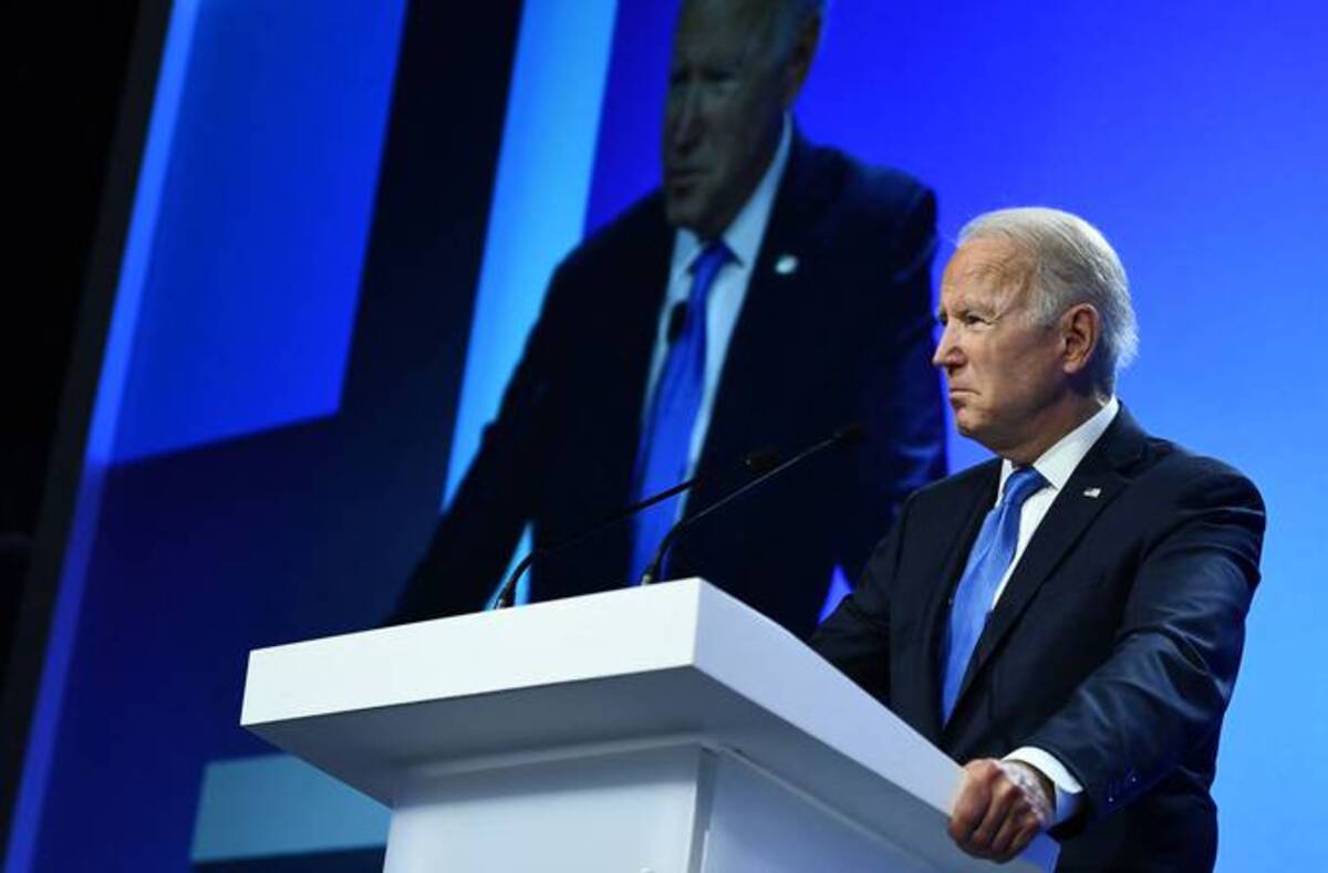 Biden reacts as he delivers a speech onstage during a meeting, as part of the World Leaders' Summit of the COP26 U.N. Climate Change Conference in Glasgow, Scotland, today. (Brendan Smialowski/AFP)&nbsp;
