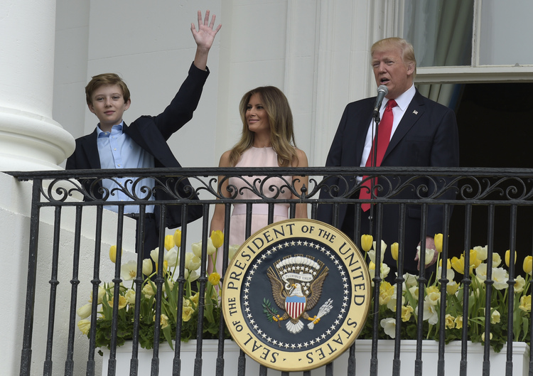 Barron Trump waves to the crowd from the Truman Balcony during the Easter Egg Roll. (Susan Walsh/AP)</p>  