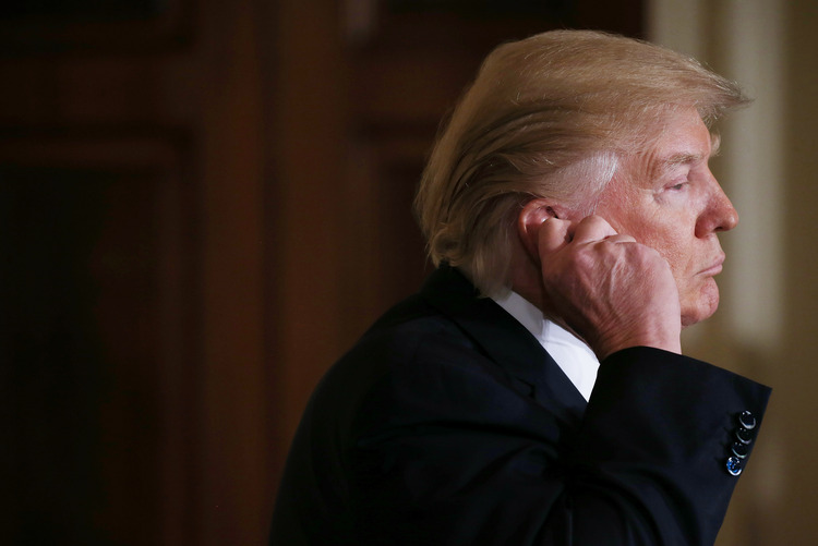 Trump listens to translation during a joint press conference on Friday.&nbsp;(Mario Tama/Getty)</p>  