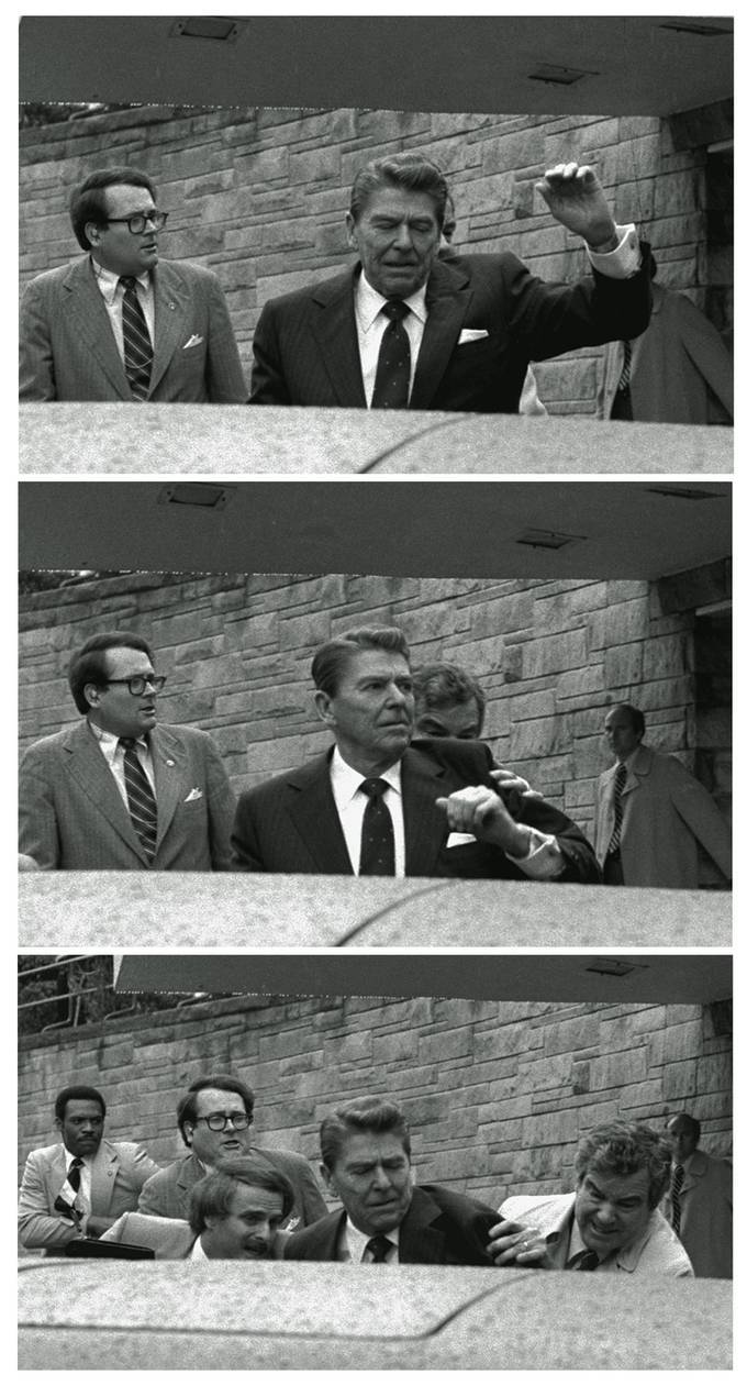 In this March 30, 1981 photo, President Ronald Reagan waves, then looks up before being shoved by Secret Service agents after being shot outside a Washington hotel. A Secret Service audiotape from the attempted assassination released in 2011 shed light on the chaotic aftermath, when neither the president nor his agents realized he'd been shot. (Ron Edmonds/AP)