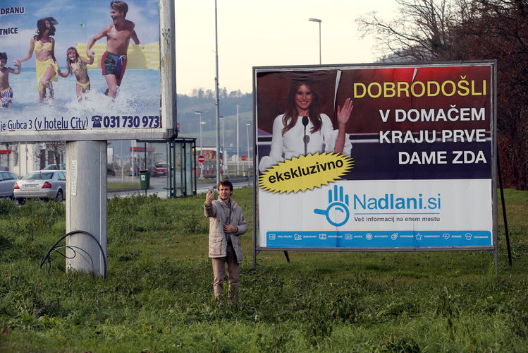 A man takes a selfie in front of placard with a picture of Melania Trump in her hometown of Sevnica, Slovenia. The banner reads, "Welcome in hometown of first lady of U.S." (Srdjan Zivulovic/Reuters)</p>  