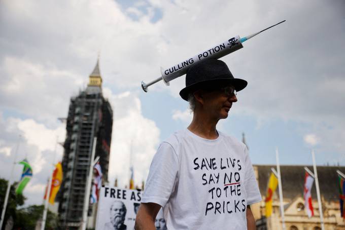 Anti-vaccination protesters against the coronavirus vaccine gather in Parliament Square in London on Monday. (Tolga Akmen/AFP/Getty Images)