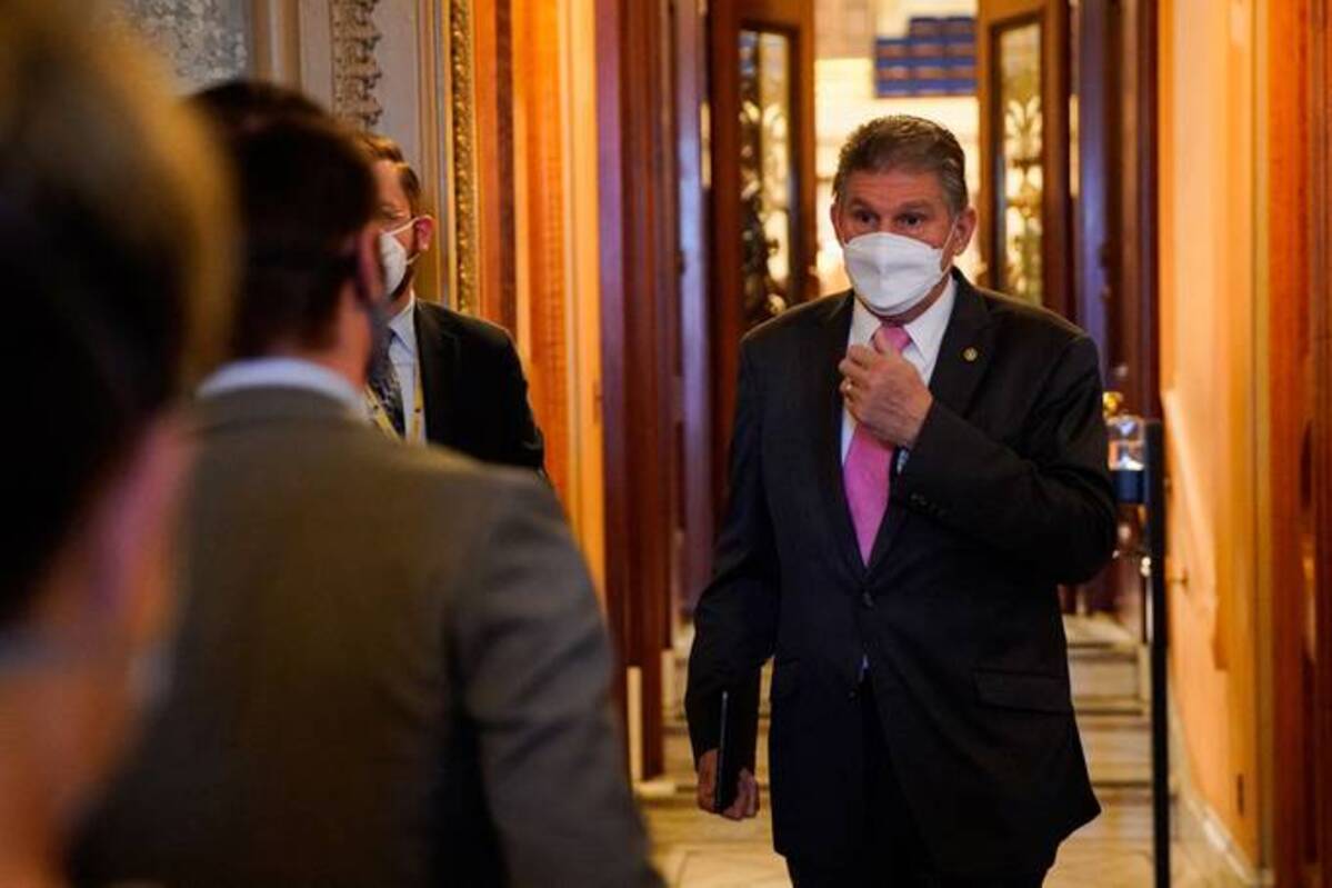 Sen. Joe Manchin III (D-W.Va.) speaks with reporters on Jan. 20. (Elizabeth Frantz/Reuters)