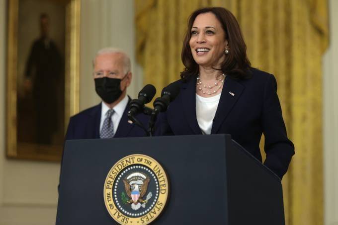 Vice President Harris speaks as President Biden listens in the East Room of the White House after the Senate passed the Infrastructure Investment and Jobs Act on Aug. 10.